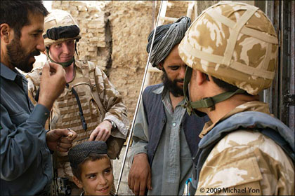 f_soliders_afghans_boy_yon.jpg