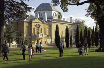 Adults and children view Chiswick House from the sunny garden