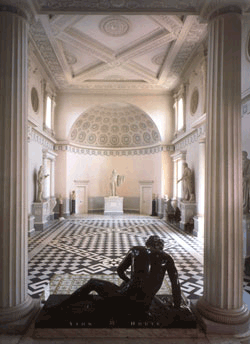 Great hall with black & white paving, high white ceilings, and sculpture