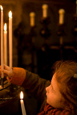 child lighting candles