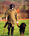 Man with gun and dog in country