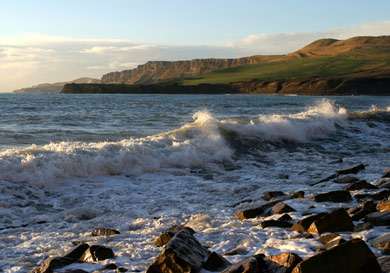 England's south coast, steep green hills and the English Channel