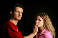 Boy tries to close girl's mouth