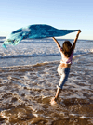 Girl running exultantly on beach