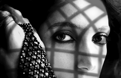 Dark-eyed Indian woman looks at us with beautiful dark eyes