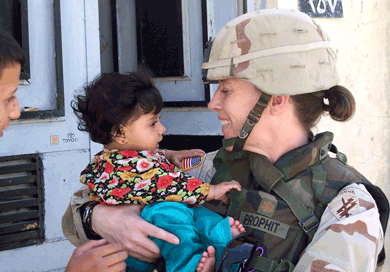 American major in Iraq holds baby in arms