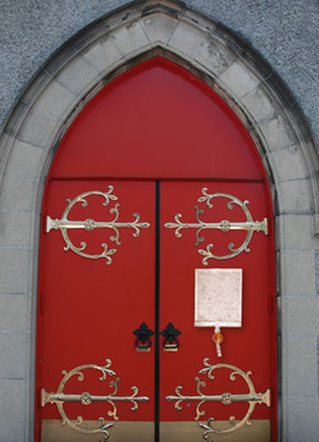 Red church doors with a copy of Magna Carta nailed to the door as the Archbishop had ordered