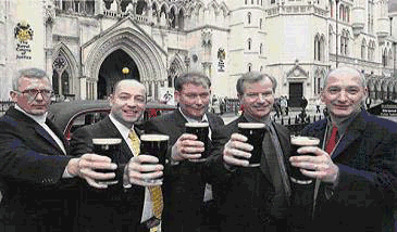 The Metric Martyrs lift pints of beer outside court