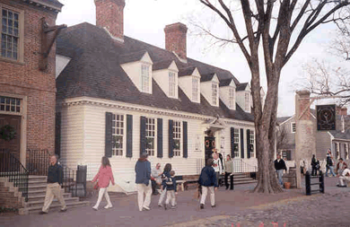 Tourists walk in front of Raleigh Tavern, Williamsburg, Virginia