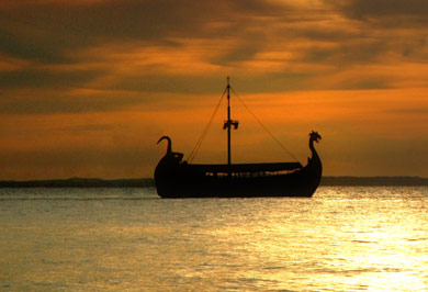 Viking ship on sea with sunset