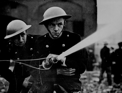 London firemen work tirelessly to put out the flames of London bombed by the Nazis