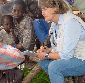 Baroness Cox in the field talks with African children