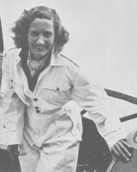 Pioneer Pilot Beryl Markham smiles as she stands at door of plane 