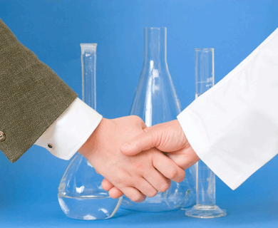 Test tubes in background as scientist and sponsor shake hands