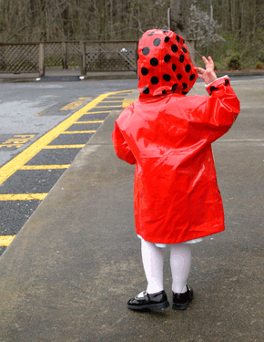 Little girl in red and black-spotted ladybird macintosh