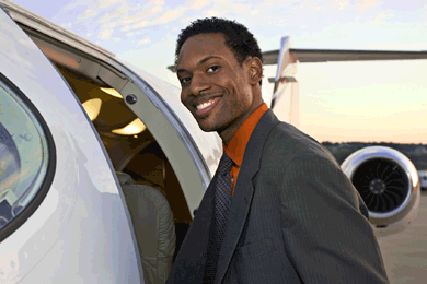 Man about to board small plane smiles