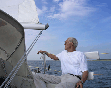 Older sailor relaxing and looking at clouds