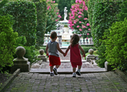 Two small children entering garden hand in hand