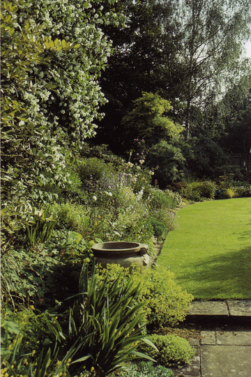 Thomas's garden showing stone flags, grass, lovely beds and trees