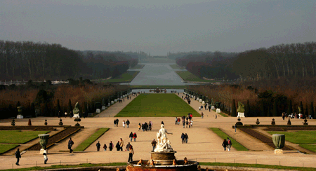 Vast Versailles gardens with statues, immense rectangular pools