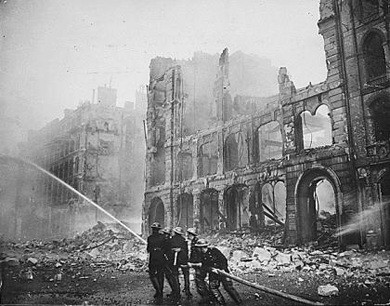Firemen work tirelessly to put the fires caused by Nazi bombing during the Blitz